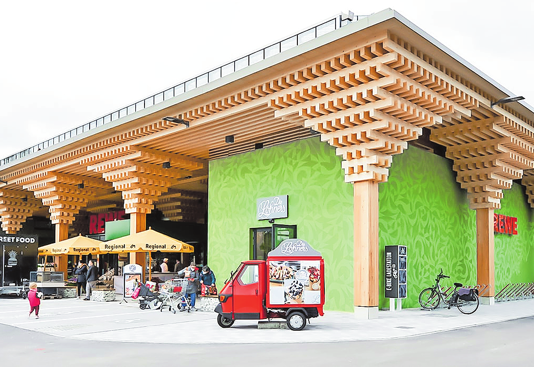 ABBILDUNGEN: DEN PROTOTYP FÜR DEN SUPERMARKT, DER NUN IN SERIE GEHT, LIESS REWE IN WIESBADEN-ERBENHEIM BAUEN. DORT SIND ALLE ELEMENTE DER NEUEN BAUWEISE ENTWICKELT UND ERPROBT WORDEN. DAHER DIE LANGE BAUZEIT VON 2016 BIS 2021. FOTO: ACME, JEVA GRISKJANE