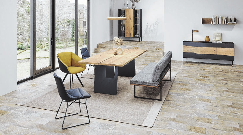 Neben geradliniger Formsprache finden sich Tische mit einer Baumkante.   Foto: IPM/Wimmer