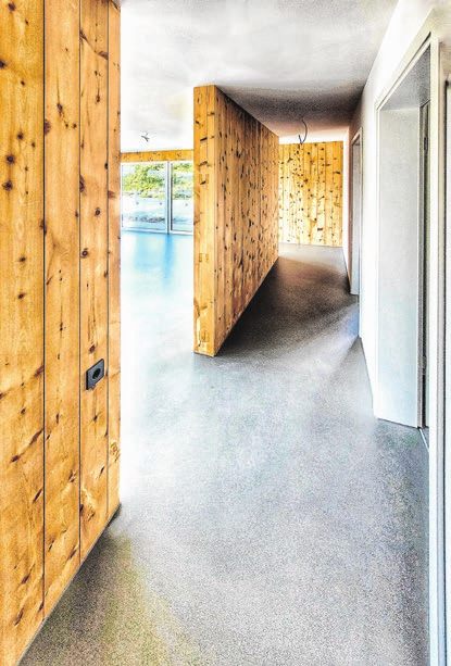 Der wohlige Wärme vermittelnde, nachhaltige Baustoff Holz dominiert auch die Flure im Casa Legno.