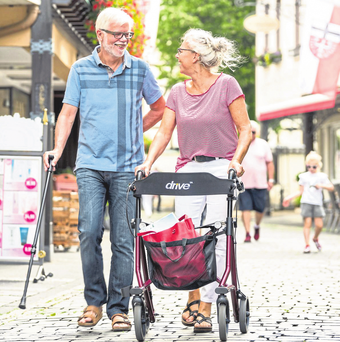 Mobilität bedeutet Teilhabe: Mit Gehstock und Rollator ist ein Paar in der Niederhutstraße von Ahrweiler unterwegs.
