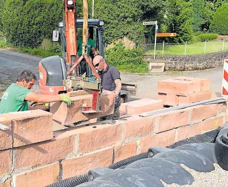 Mitarbeiter des Unternehmens bei Arbeiten an einer Grundstücksumrandung. FOTO: MANFRED WELLER